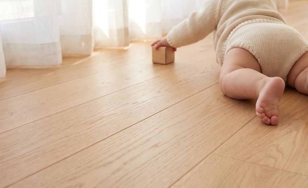 やわらかな光が差し込む無垢の床の上で、はだしで遊ぶ赤ちゃん